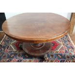 A William IV circular mahogany breakfast table, on a platform and paw shaped feet,