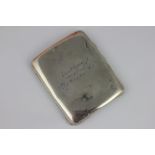 A silver cigarette case engraved 'In Memory of Capt.