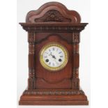 A late 19th century carved oak eight day bracket clock,