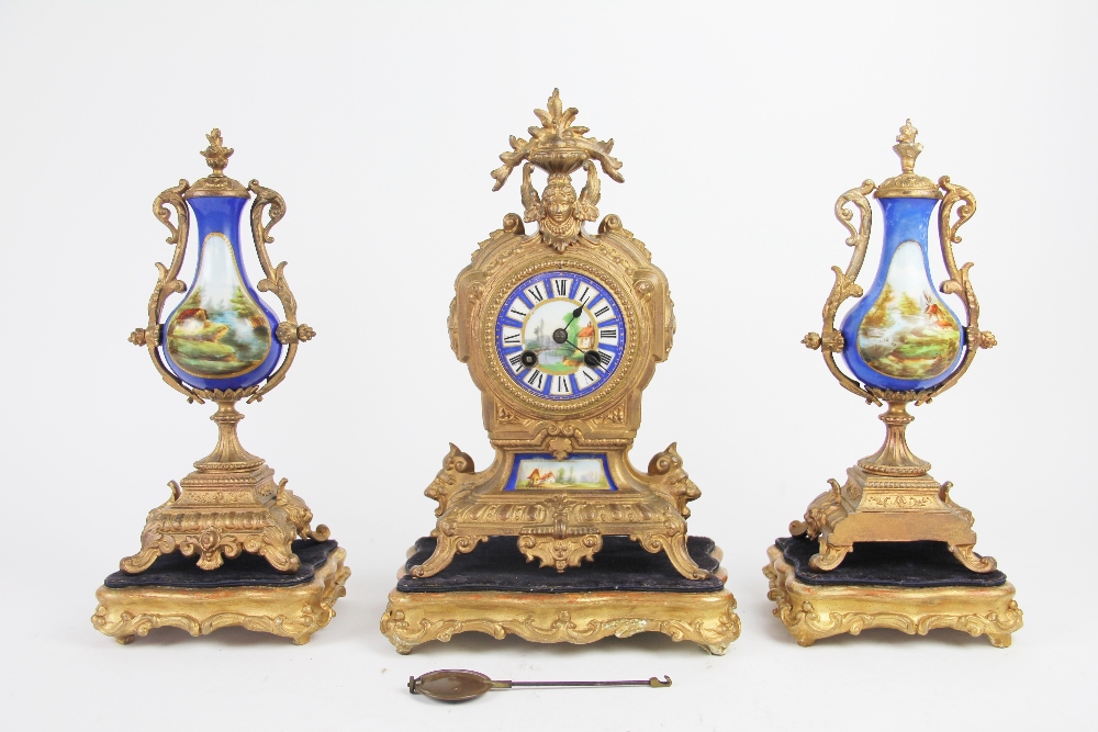 A mid 19th century French gilt metal clock garniture,