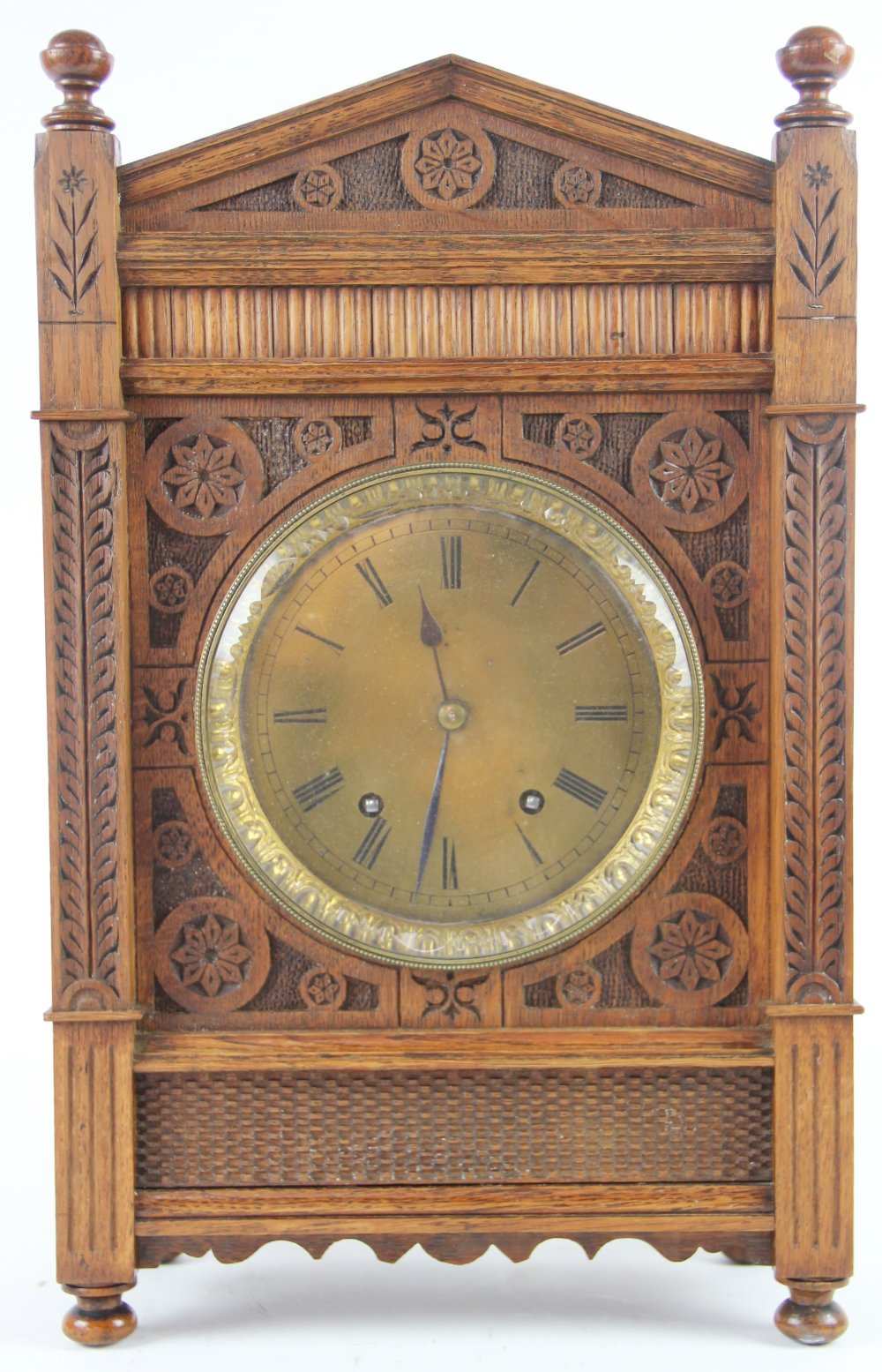 An Aesthetic carved oak eight day bracket clock, late 19th century, faceted glass bezel,