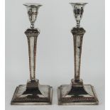 A pair of 19th century silver plated candlesticks, of Adam design,