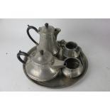 An Arts and Crafts pewter five piece tea set, with faux riveted and hammered decoration,