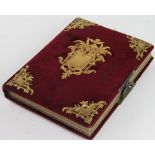 A Victorian photograph album, the velvet covered album with gilt metal mounts,