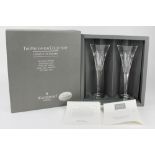 A pair of Waterford crystal Millennium Collection champagne flutes, decorated with hearts,