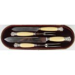 A Victorian silver mounted ivory four piece carving set, each terminal modelled with a rams head,
