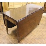 A George III mahogany drop leaf dining table, each leaf with a rounded corner,