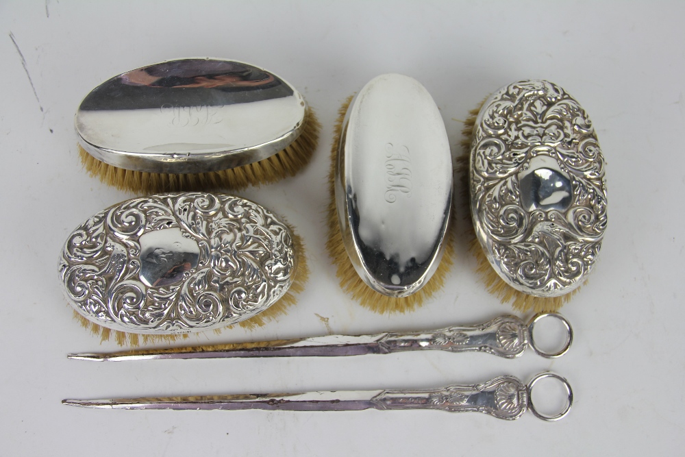 Two pairs of Victorian silver backed dressing table brushes,