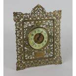 A late Victorian gilt brass strut time piece, of pierced folaite form,