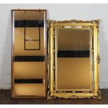 A golden oak wall mirror, with bevelled plate, 94cm x 38cm; with a gilt wood wall mirror,