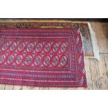 A Bokhara wool ground rug, worked with sixteed gulls against a blue and red ground,