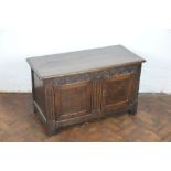 A low two door oak cupboard, 17th century and later timbers, with carved detailing, on stile feet,