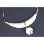 An ivory bead and gold set necklace, Egyptian circa.