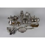 Two silver backed dressing table brushes and a hand mirror along with a collection of silver plated