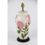 A Moorcroft Magnolia pattern lamp base, the pink blooms against a cream ground,