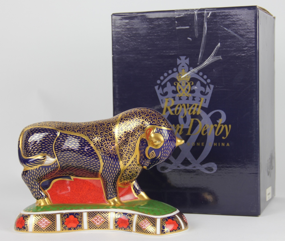 A Royal Crown Derby Bull paperweight LVIII, the cobalt bull raised on kidney shaped base,