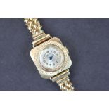 A Majek 9ct yellow gold lady's wristwatch, the cushion shaped face with circular silvered dial,