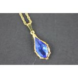 A 9ct yellow gold and blue stone set pendant, of faceted drop shape, stamped 'W.