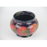 A William Moorcroft Pomegranate pattern bowl, impressed marks and number 5S and green signature,