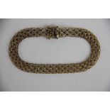 A 9ct yellow gold mesh bracelet, with integral clasp and double safety catch, stamped '375',