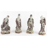 Four Japanese glazed earthenware figures, three sages and geisha,