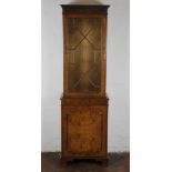 A modern walnut display cabinet, with astragal glazed door and cupboard door, on stile feet,