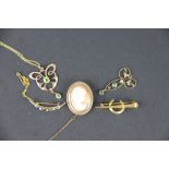 A Deakin and Francis Art Nouveau gold pendant, set with peridots and with attached fine chain,