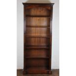 A modern mahogany open bookcase, with four adjustable and one fixed shelf, on plinth base,