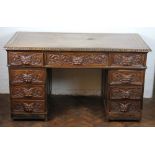 A late Victorian carved oak pedestal desk,