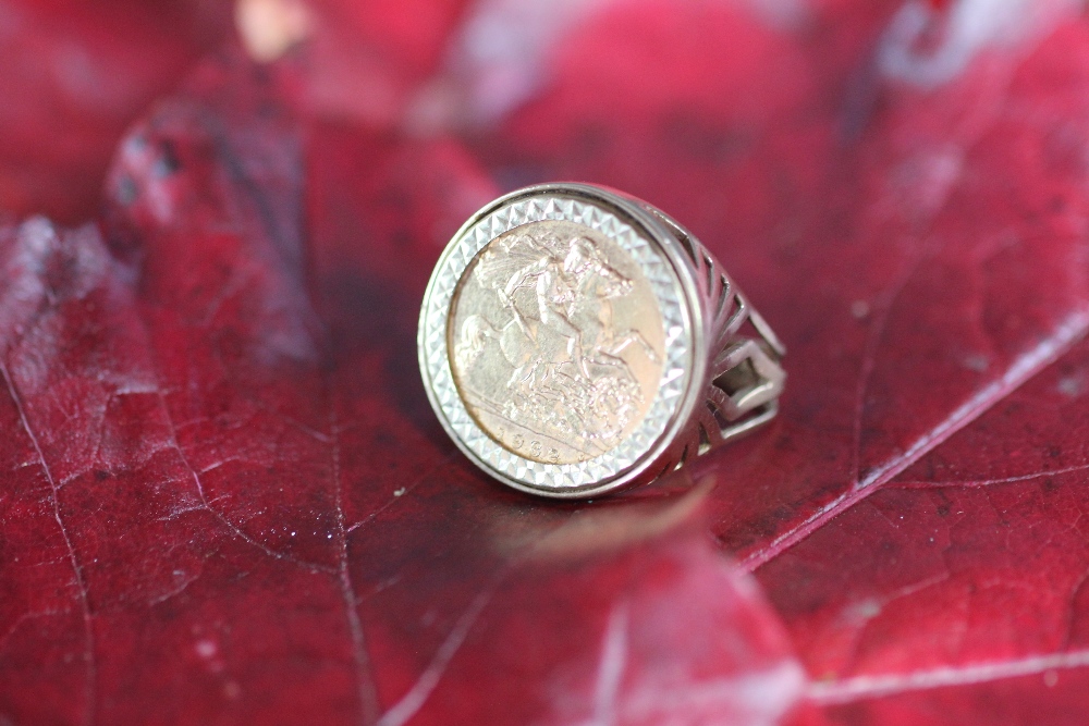 A gold half sovereign set ring dated 1982, within 9ct yellow gold mount, weight 8.