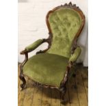 A pair of Victorian carved walnut salon chairs, with button back green upholstery,