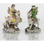 A pair of early 19th Century Pratt type figure groups of The Peddler and his Wife,