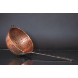 An early 19th Century copper and wrought iron colander, with loop handle and hook,