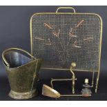 A 19th Century brass coal scuttle; a brass spark guard decorated with bull rushes;