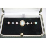 An opal and diamond bar brooch, designed as a central opal and diamond cluster,
