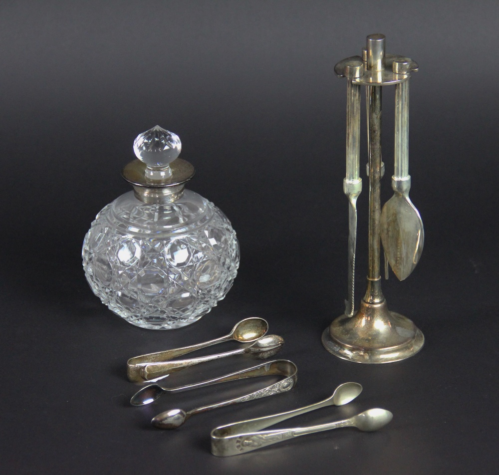 A silver collared cut glass spherical scent bottle and associated stopper,