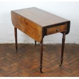 A Regency oak Pembroke table, with rounded leaves and drawer on ring turned and tapered legs,