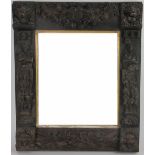 A 19th Century carved oak mirror, of 17th Century design,