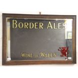 An Edwardian Border Ales Wines of Wales advertising mirror, in oak frame,