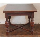A 1920s oak drawer leaf dining table, on bawster legs and block feet, with x frome base,