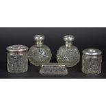 A pair of Edwardian silver mounted cut glass globular scent bottles and stoppers, Birmingham 1905,