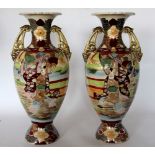 A large pair of Japanese Satsuma twin handled vases, decorated throughout with figures and flowers,