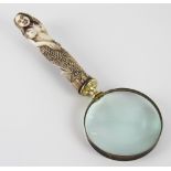 A carved bone and brass novelty magnifying glass, the handle modelled as a Mermaid,