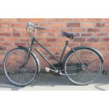 A lady's green Raleigh vintage bicycle, 3 speed with leather seat,
