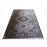 A Caucasian wool rug, worked with three gulls and all over geometric motifs against a beige ground,