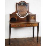 An Edwardian satinwood inlaid mahogany dressing table, with shield shaped mirror,