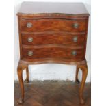A 1920's walnut serpentine chest of three drawers, on cabriole legs,