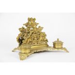 A Victorian cast brass desk stand, with two lidded ink wells, on scroll feet,