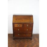 An Edwardian mahogany bureau, with fall enclosing a fitted interior,