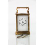 A French brass carriage time piece, with enamel Roman numeral dial,